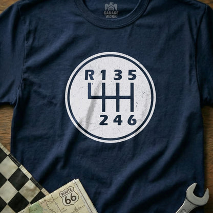 Navy t-shirt with a white circular graphic of a manual transmission shift pattern.