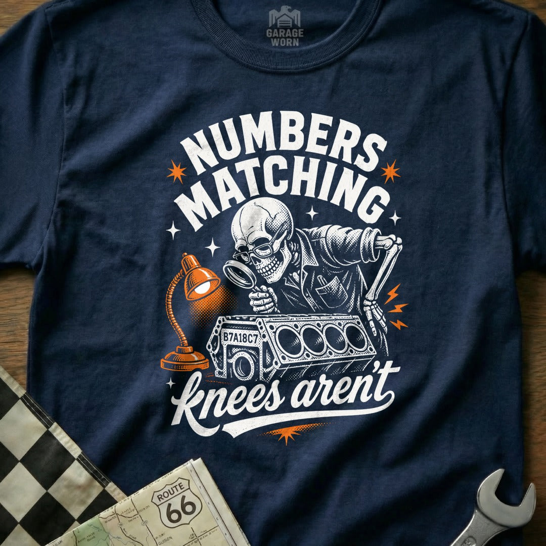Skeleton mechanic examining engine block with magnifying glass, text "Numbers Matching, knees aren't".