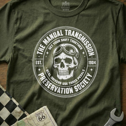 Green t-shirt with skull wearing goggles and "The Manual Transmission Preservation Society" text.