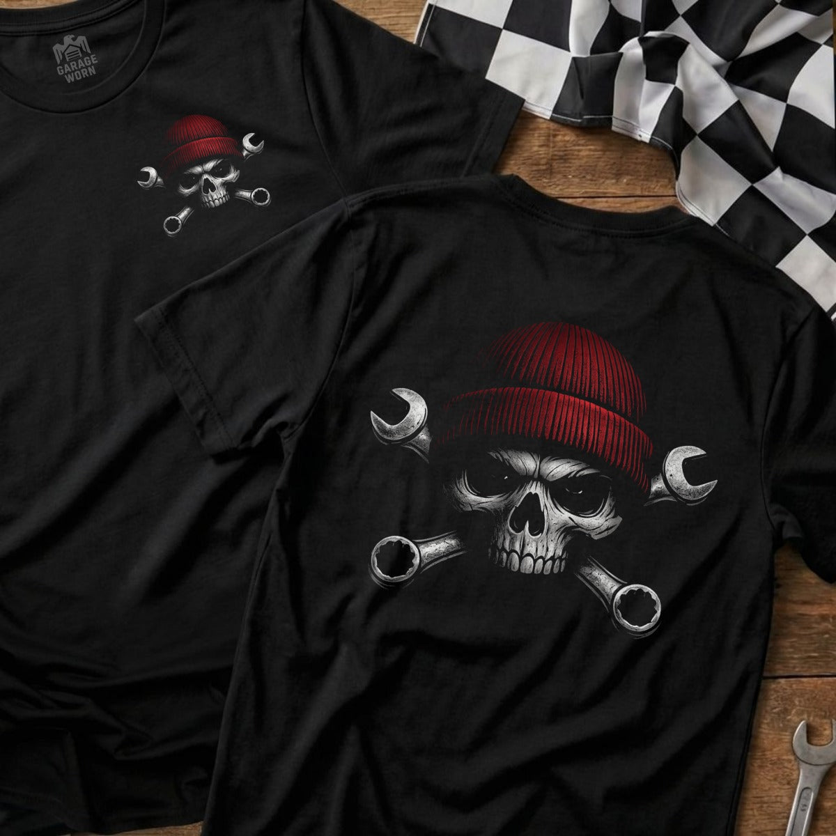 Skull wearing a red beanie, with crossed wrenches, on a black t-shirt.