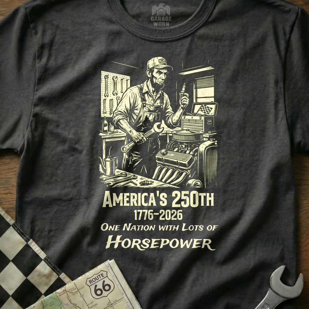 Black t-shirt with "America's 250th 1776-2026 One Nation With Lots of Horsepower" text and mechanic graphic.