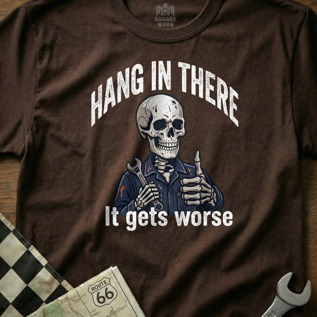 Brown t-shirt with skeleton mechanic giving thumbs up, "Hang in There It Gets Worse" text.