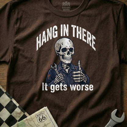 Brown t-shirt with skeleton mechanic giving thumbs up, "Hang in There It Gets Worse" text.