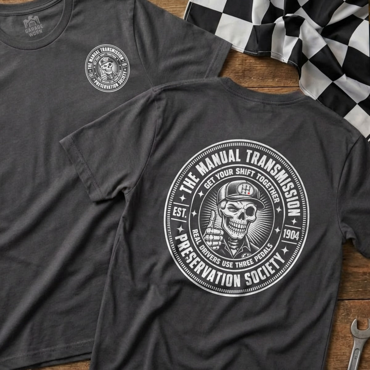 Dark grey t-shirts feature a circular graphic with a skeleton giving a thumbs-up.