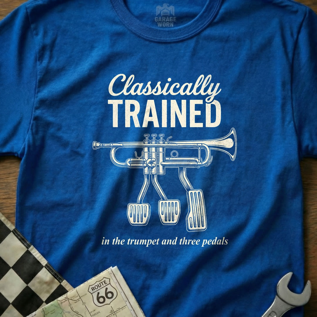 Blue t-shirt with trumpet and pedals graphic and text "Classically TRAINED in the trumpet and three pedals."