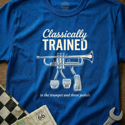 Blue t-shirt with trumpet and pedals graphic and text "Classically TRAINED in the trumpet and three pedals."