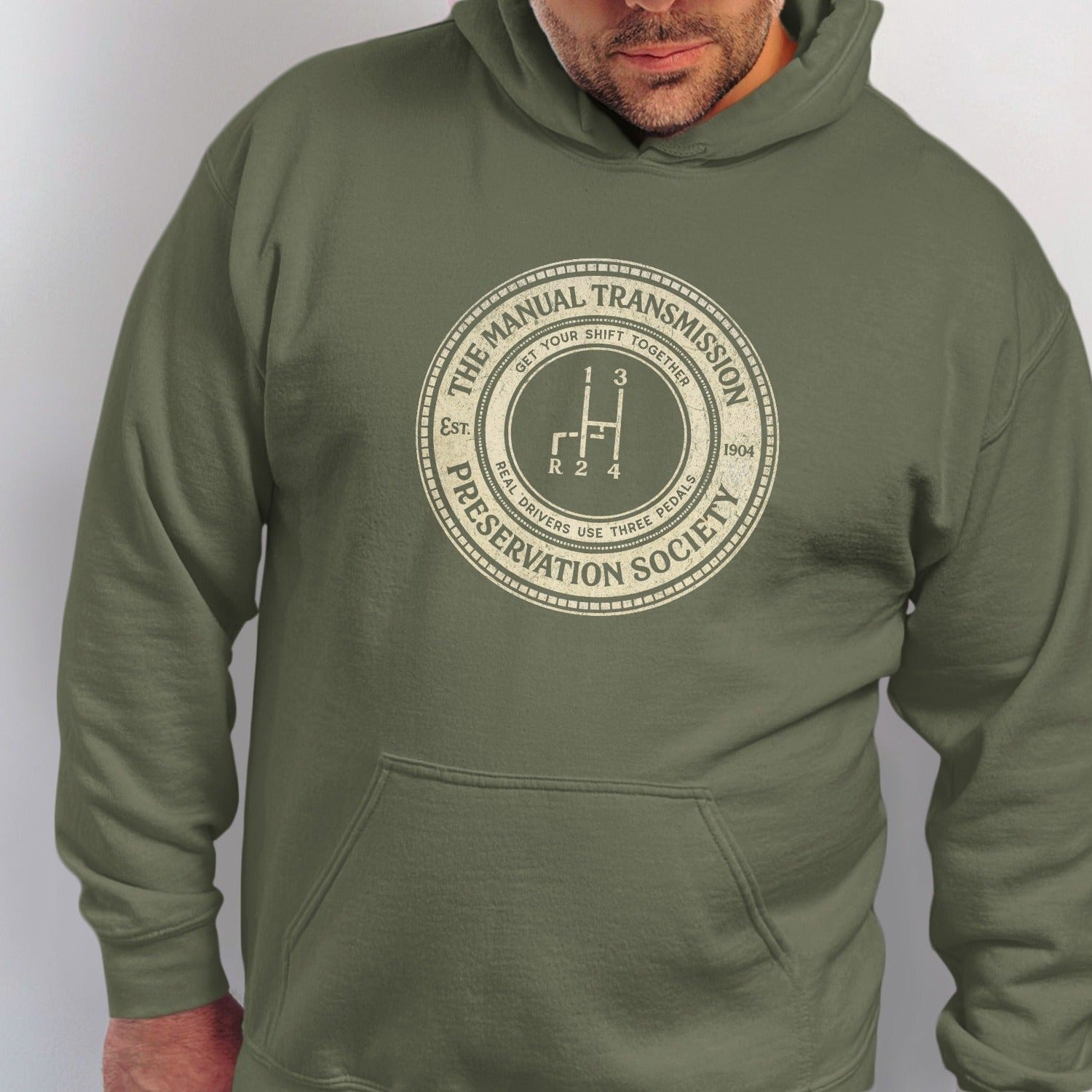 Green hoodie with circular print: "The Manual Transmission Preservation Society".