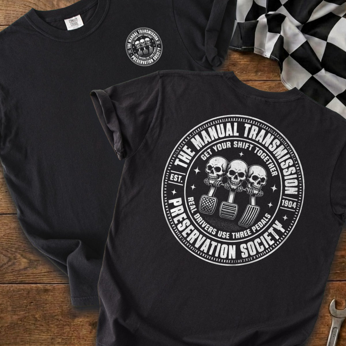 Black t-shirt with "The Manual Transmission Preservation Society" graphic featuring skulls and pedals.