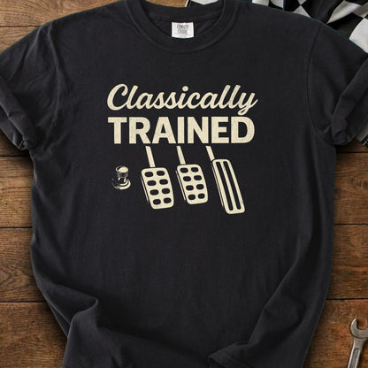 Black t-shirt with "Classically TRAINED" and three manual car pedals graphic.