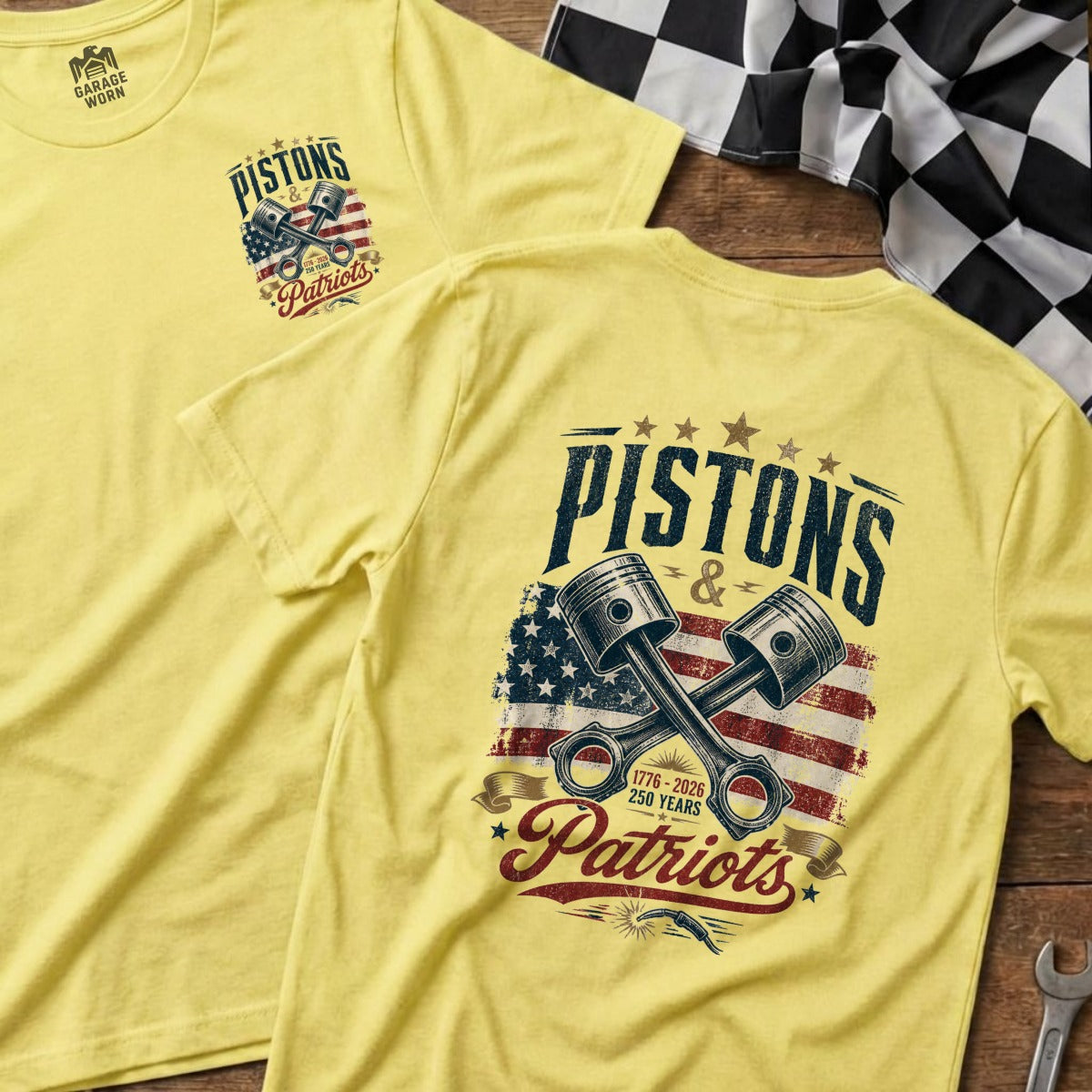 Yellow t-shirt with "Pistons & Patriots" graphic featuring pistons and American flag.