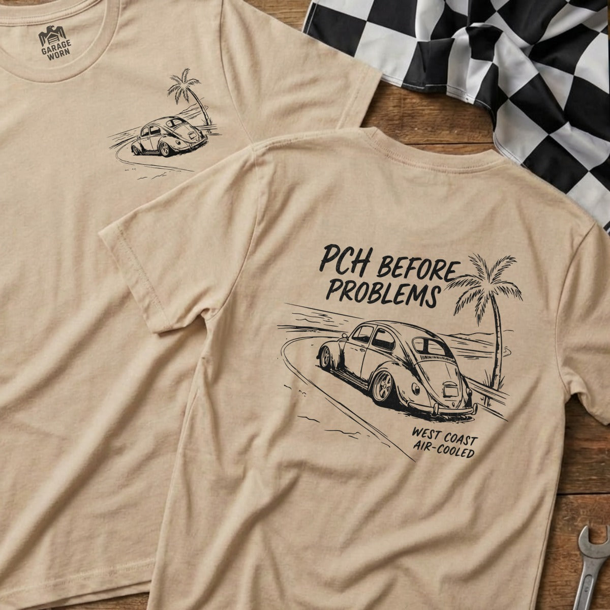 Tan t-shirt with a graphic of a classic car driving on a beach road.