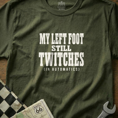 Green t-shirt with white text "MY LEFT FOOT STILL TWITCHES (IN AUTOMATICS)".