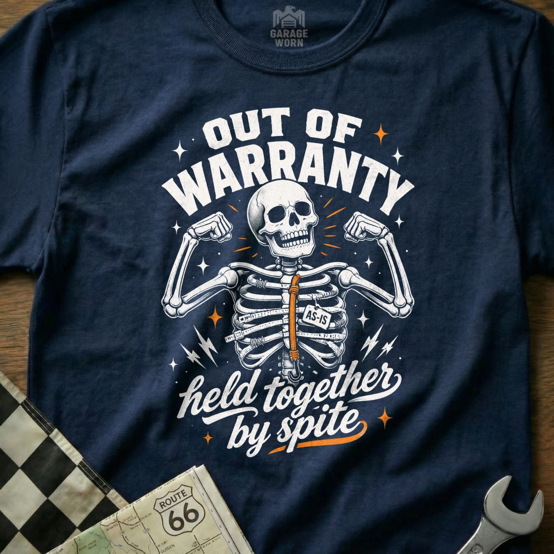 Navy t-shirt with skeleton graphic reading "Out of Warranty, Held Together by Spite".