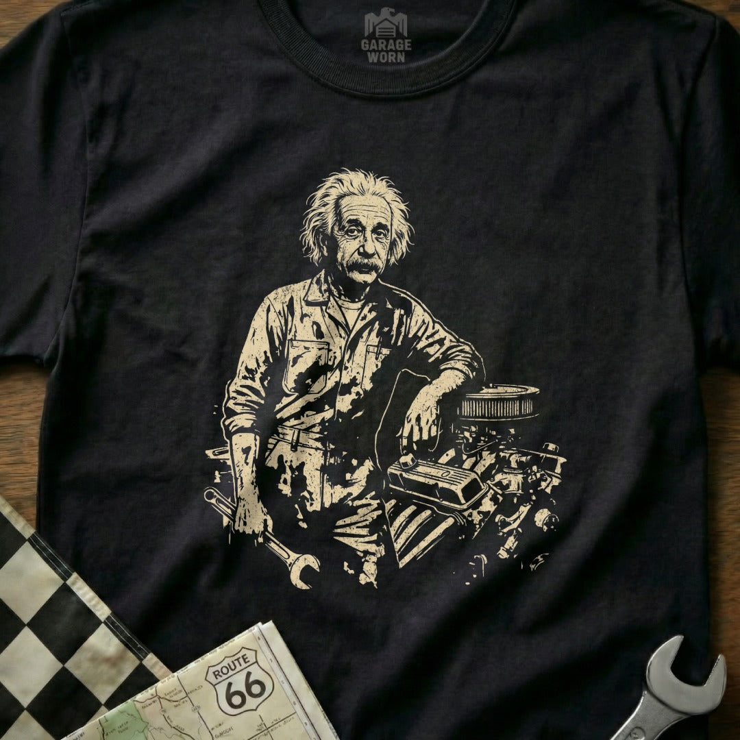 Albert Einstein leaning on engine parts, holding a wrench, on a t-shirt.