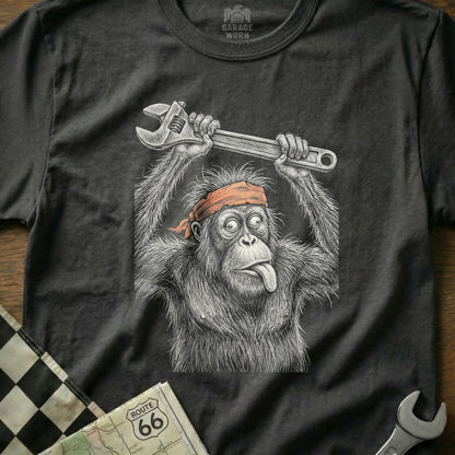 Orangutan wearing a bandana, holding a wrench above its head.