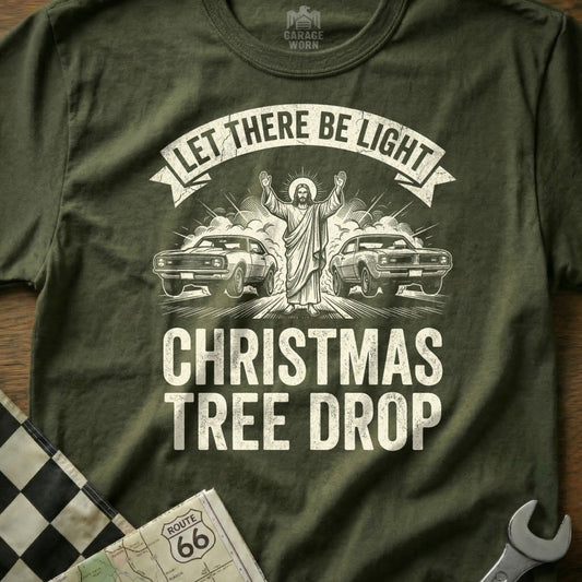 Jesus with arms raised between two muscle cars, "LET THERE BE LIGHT CHRISTMAS TREE DROP".