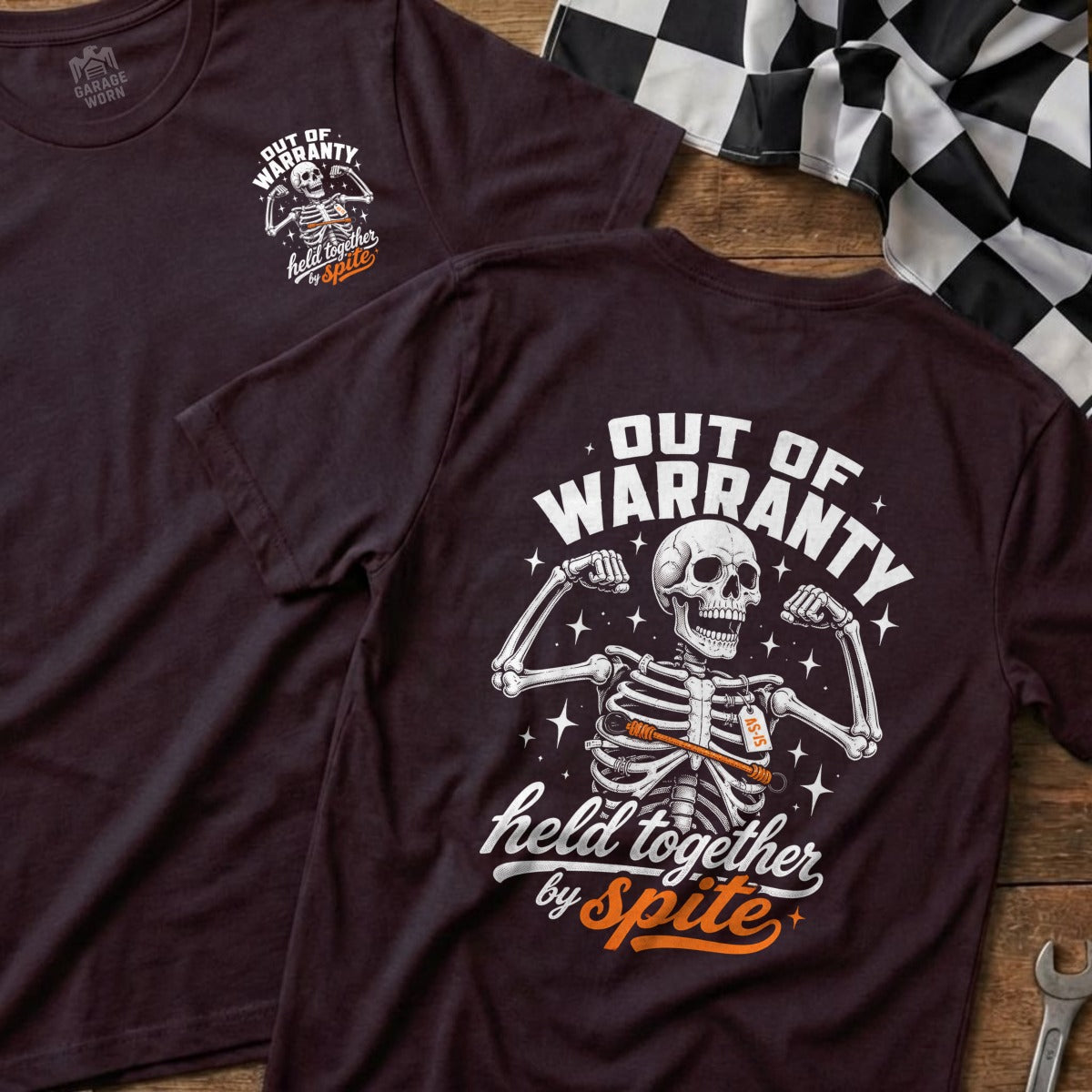 Skeleton graphic on dark shirt saying "Out of Warranty, Held Together by Spite."