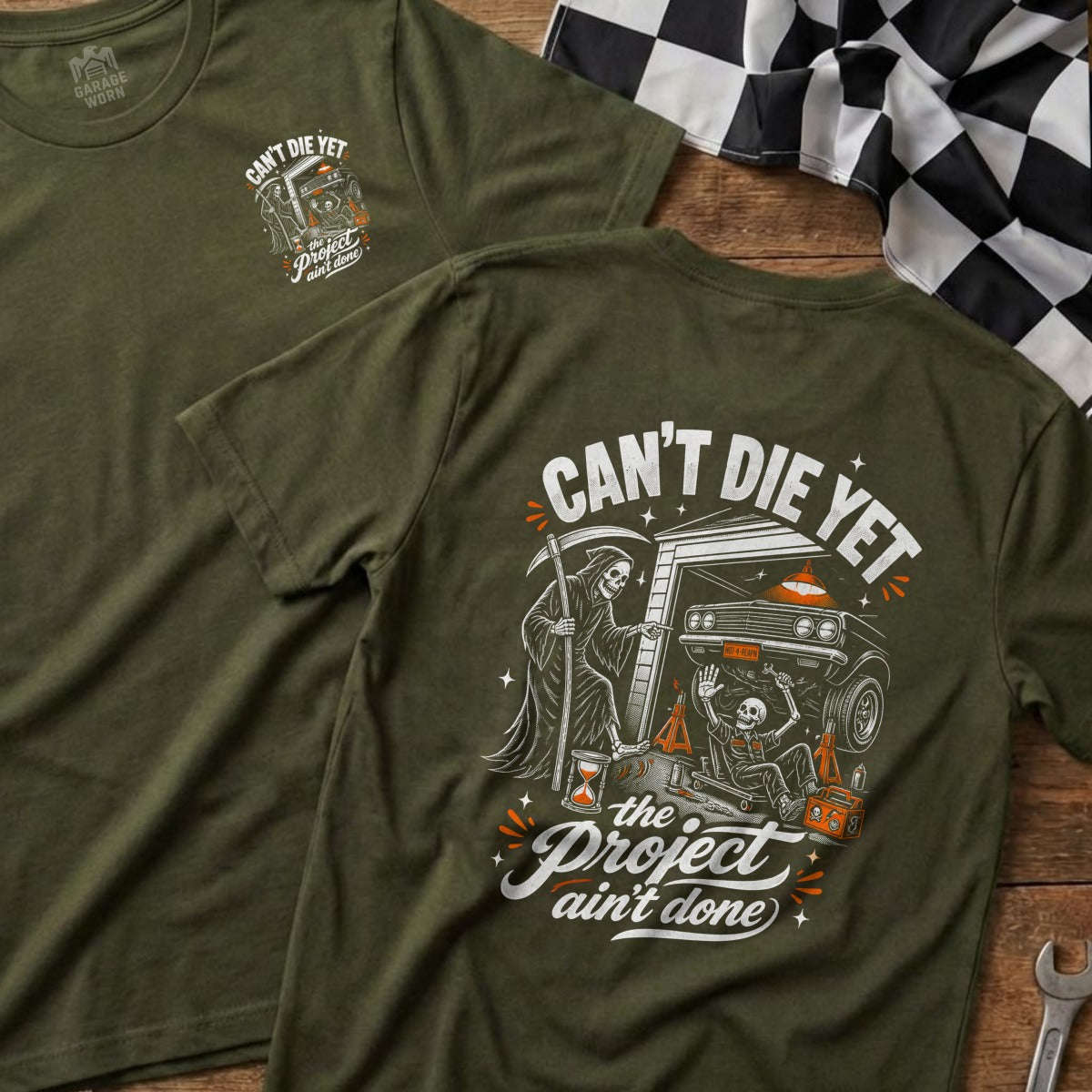 Green t-shirt with Grim Reaper, skeleton, and car graphic; "Can't Die Yet, The Project Ain't Done".