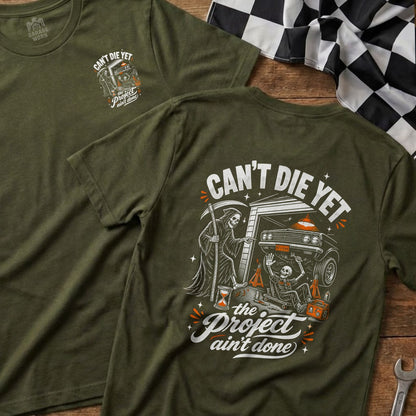 Green t-shirt with Grim Reaper, skeleton, and car graphic; "Can't Die Yet, The Project Ain't Done".