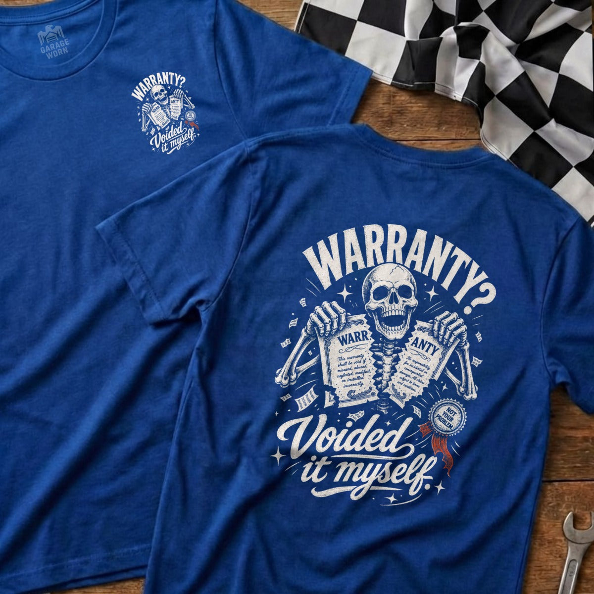 Blue t-shirt with skeleton holding warranty papers and text "Voided it myself".