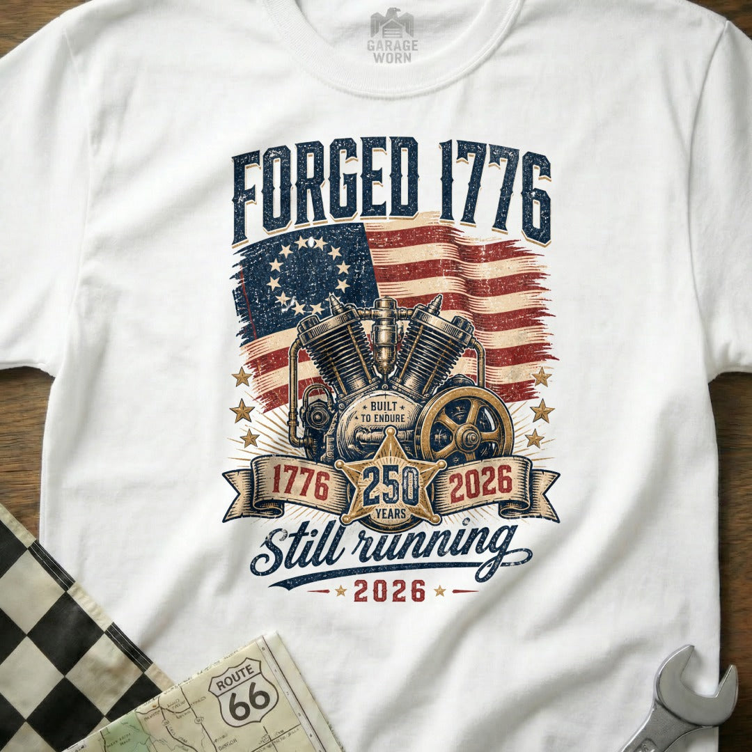 White t-shirt with a vintage motorcycle engine, US flag, and text "Forged 1776 Still Running 250 Years".
