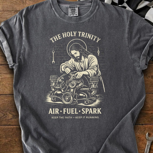 Jesus working on an engine titled "The Holy Trinity" with text "Air Fuel Spark".