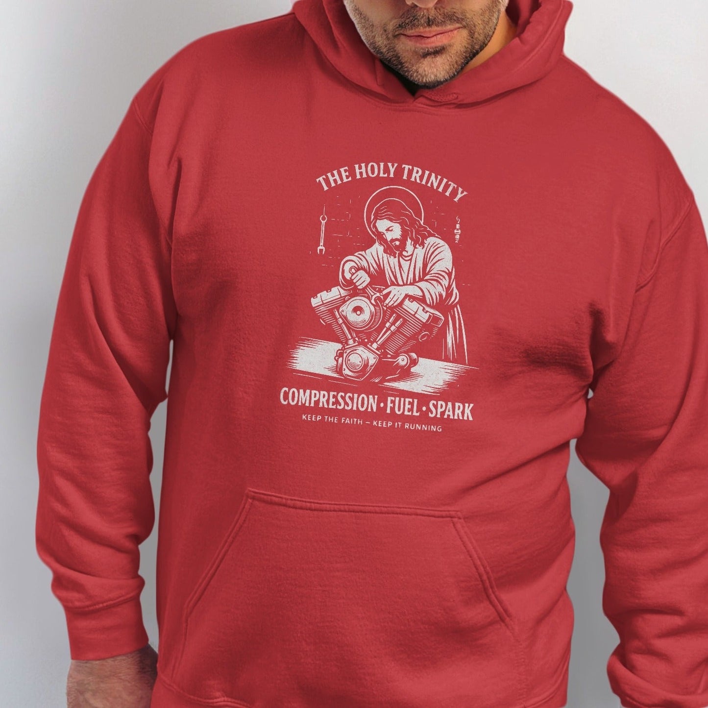 Red hoodie with white graphic of Jesus working on a motorcycle engine.