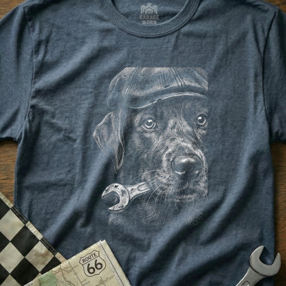 Dog wearing a cap and holding a wrench, charcoal sketch on a t-shirt.