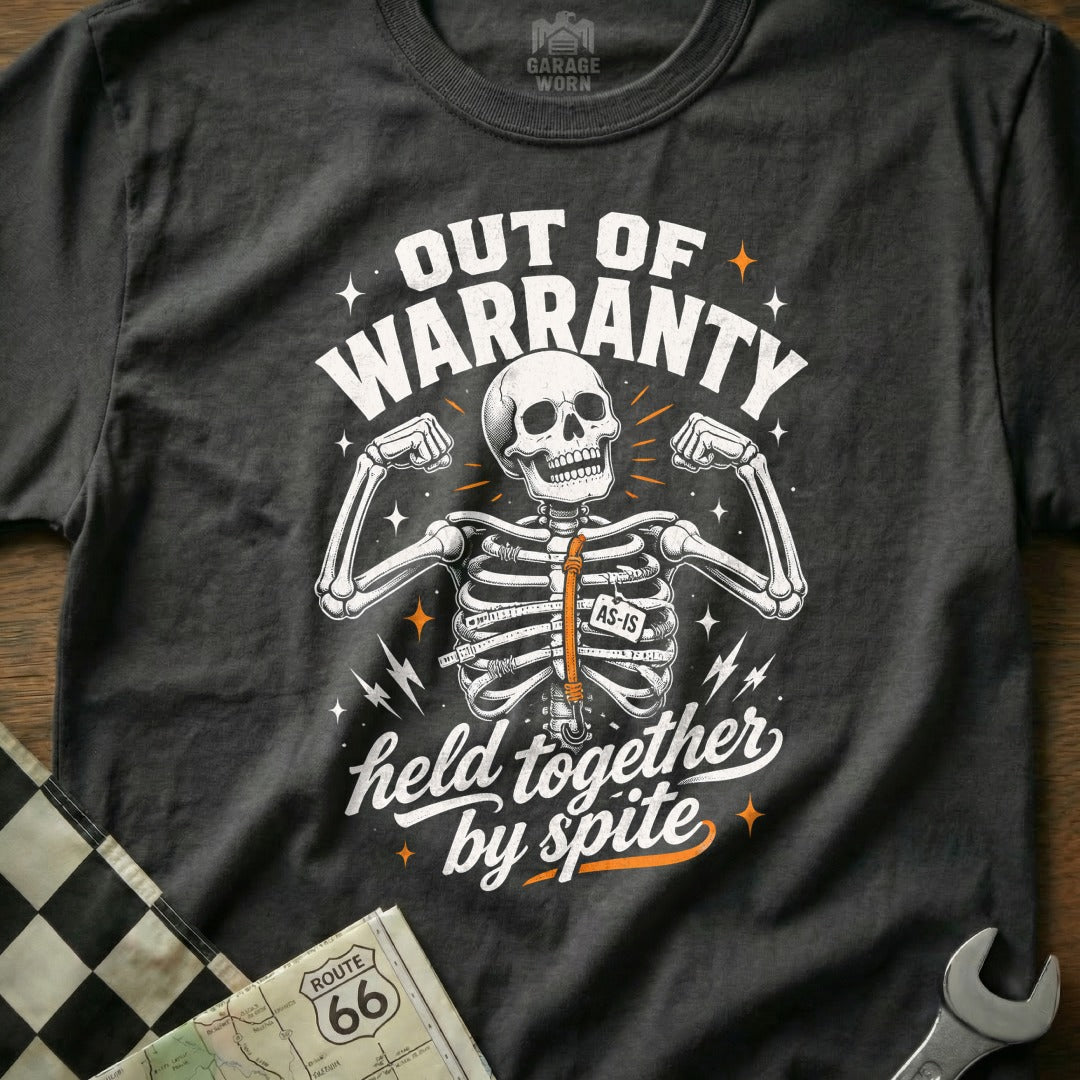 Black t-shirt with skeleton graphic, "OUT OF WARRANTY" and "held together by spite" text.