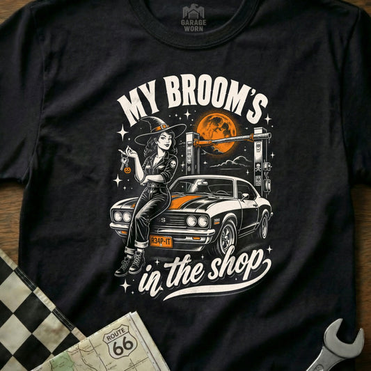 Witch with keys sits on car under moon with text "My Broom's in the shop".
