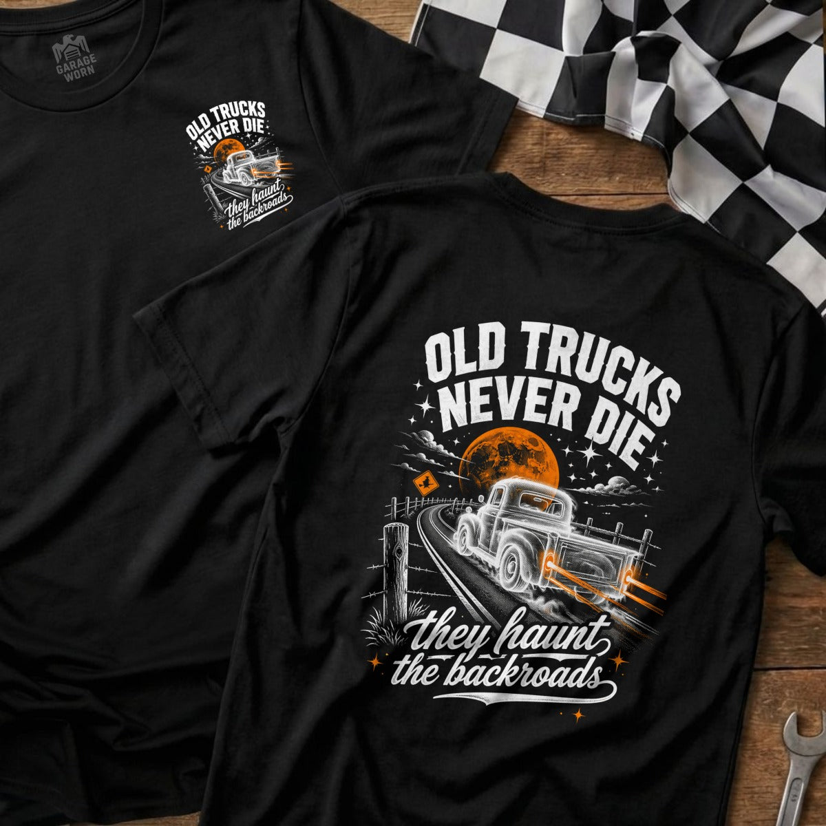 Black t-shirt with graphic of old truck on a road, text reads "Old Trucks Never Die".
