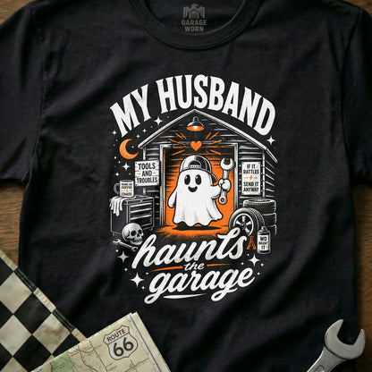 "My Husband Haunts the Garage" graphic t-shirt with a cartoon ghost mechanic.