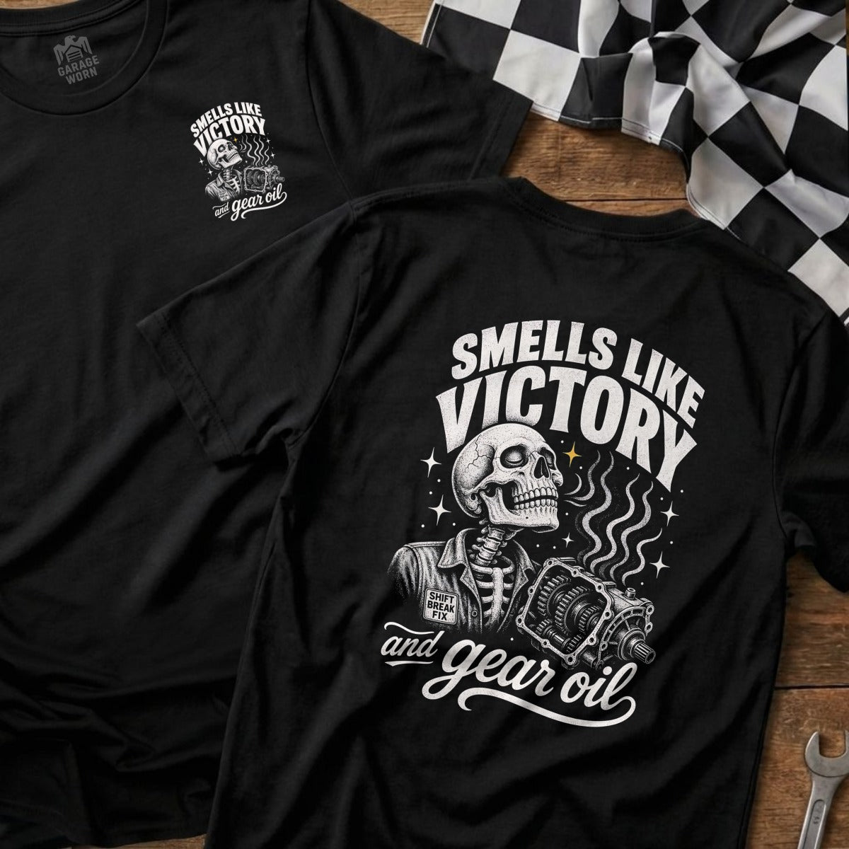 Black t-shirt with skeleton holding gearbox design and "Smells Like Victory and Gear Oil" text.