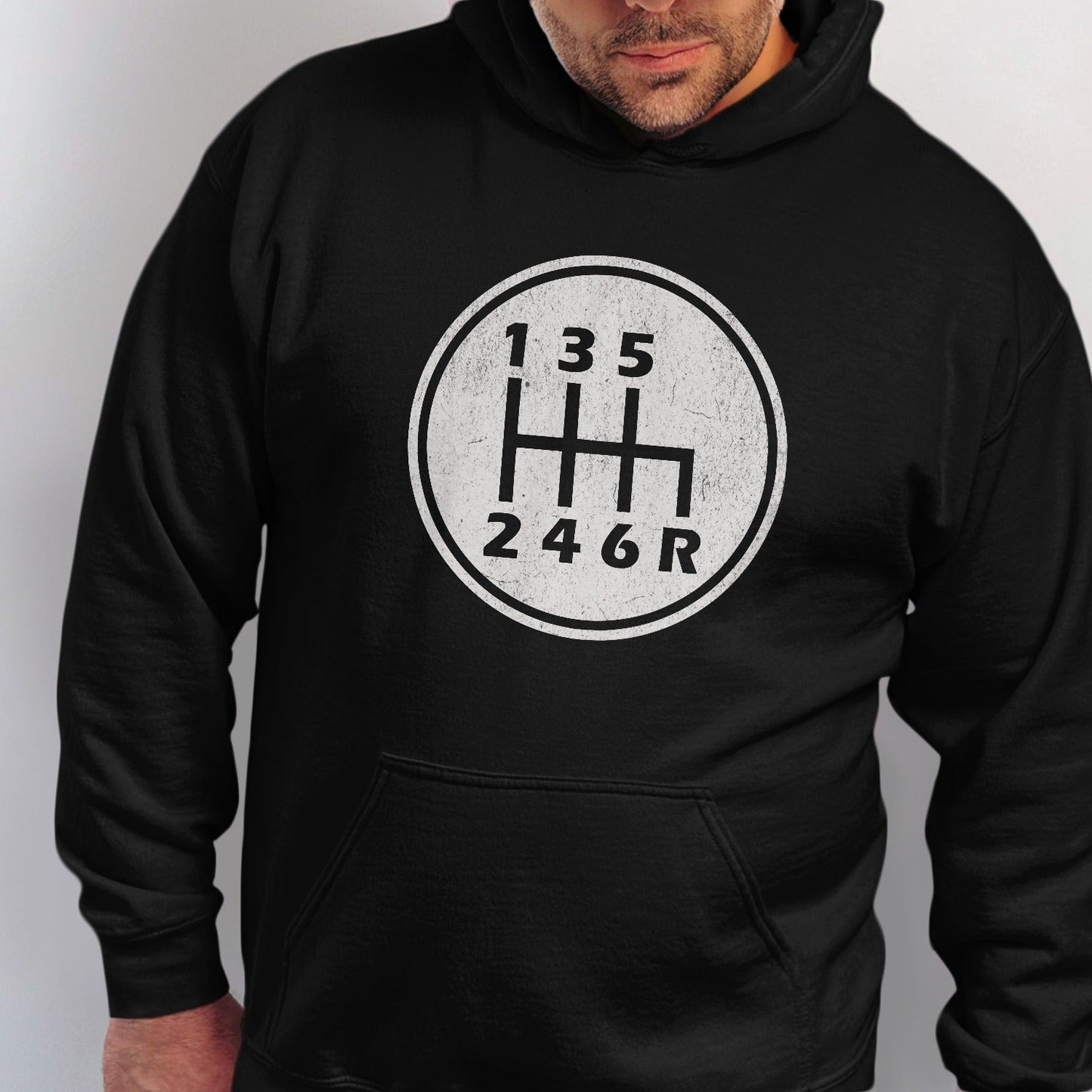 Black hoodie with a manual transmission gear shift pattern graphic.