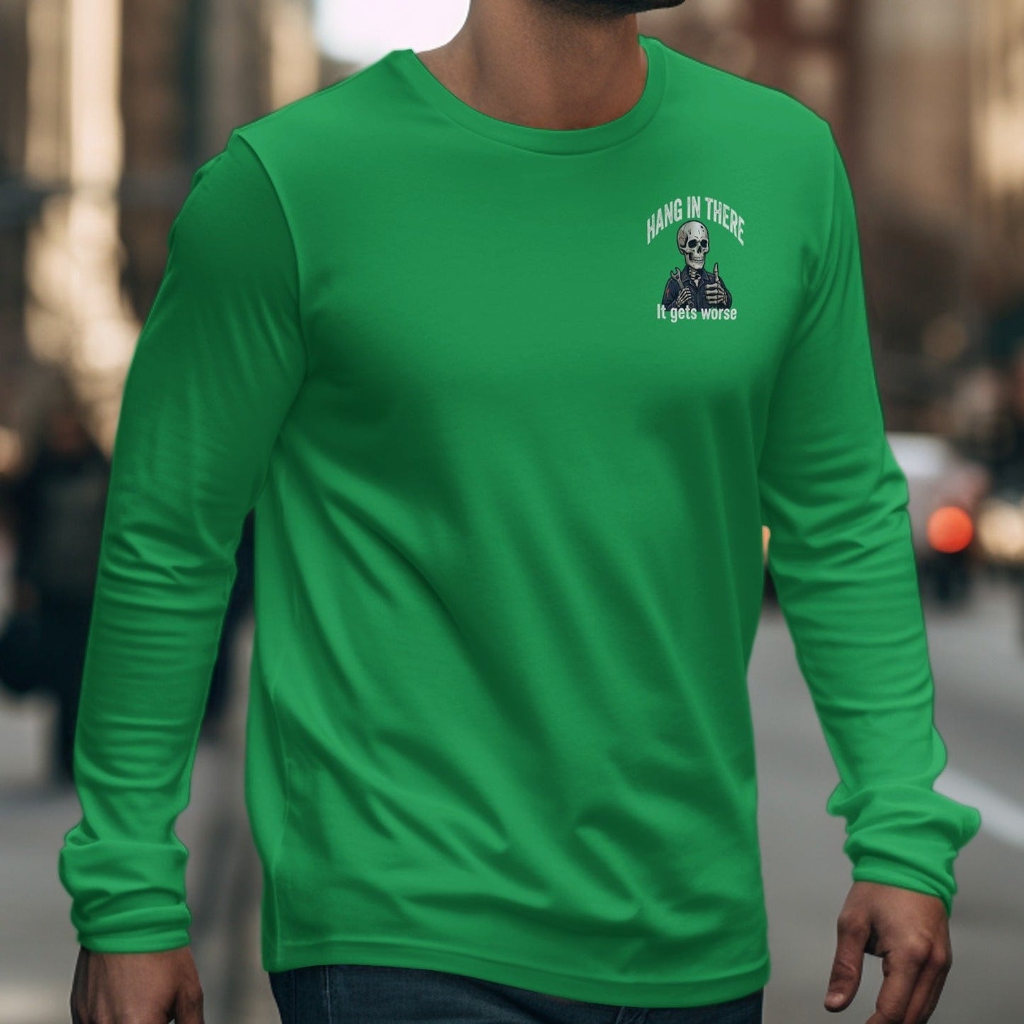 Green long-sleeve shirt with a skeleton graphic holding thumbs up and text.