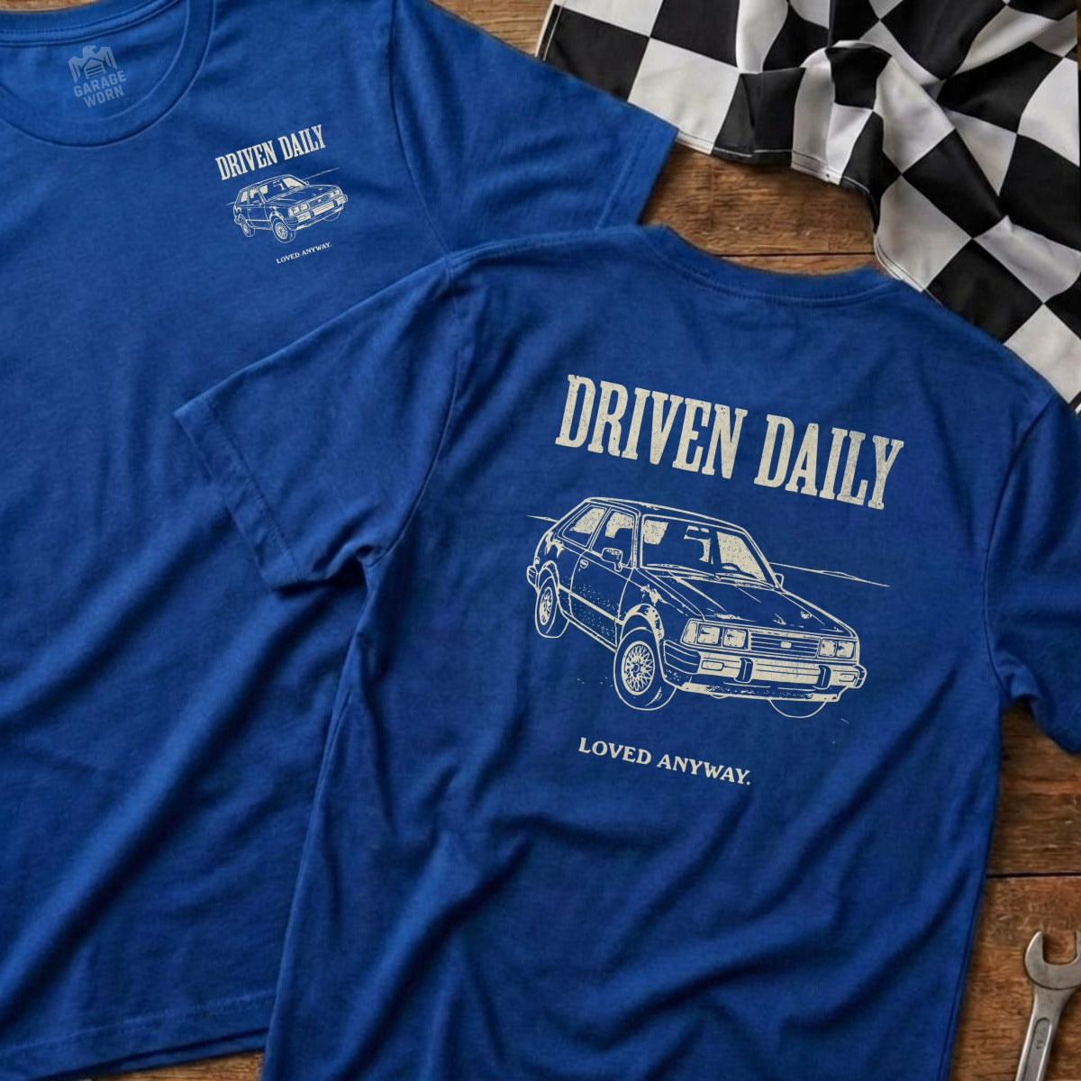 Blue t-shirts with "DRIVEN DAILY" and a car graphic, one front, one back.