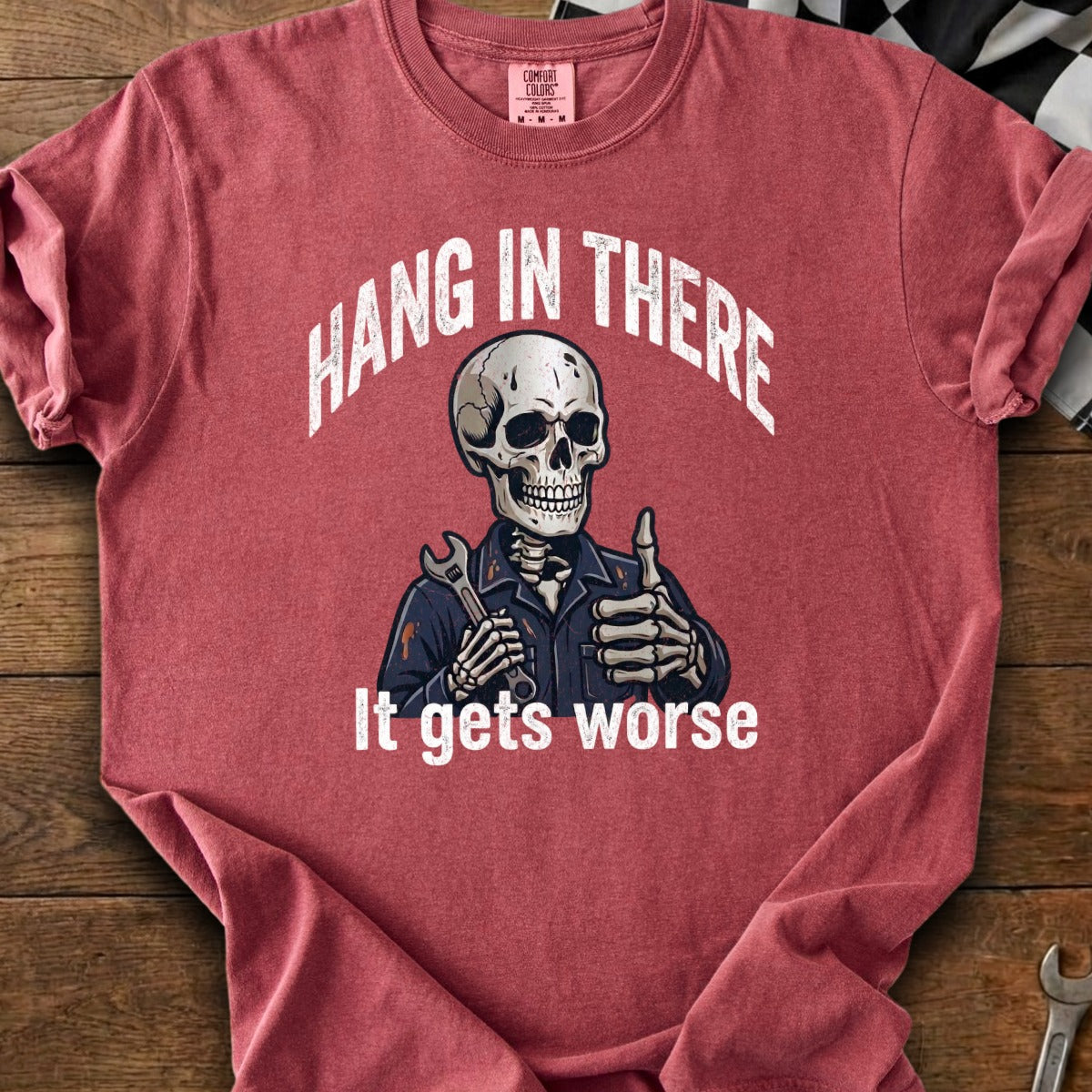 Red t-shirt with skeleton graphic saying "Hang in There. It gets worse."