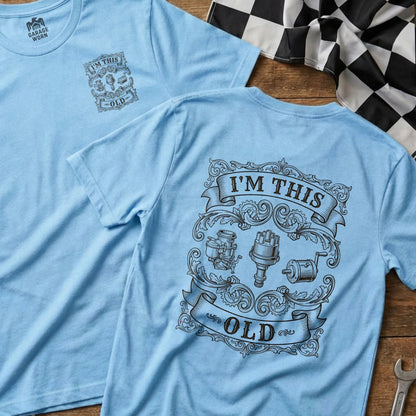 Light blue t-shirt with vintage engine parts graphic and "I'M THIS OLD" text.