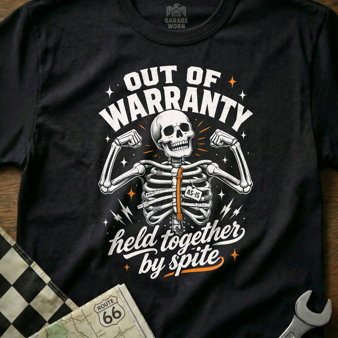 Black t-shirt with skeleton flexing and text "Out of Warranty Held Together By Spite."