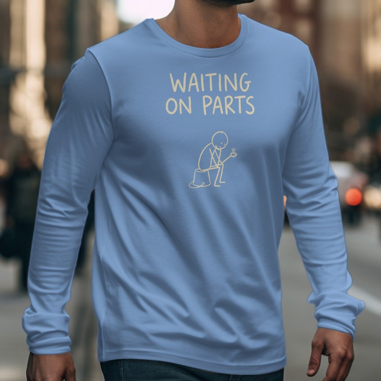 Light blue long-sleeve shirt with "WAITING ON PARTS" text and stick figure holding a screw.