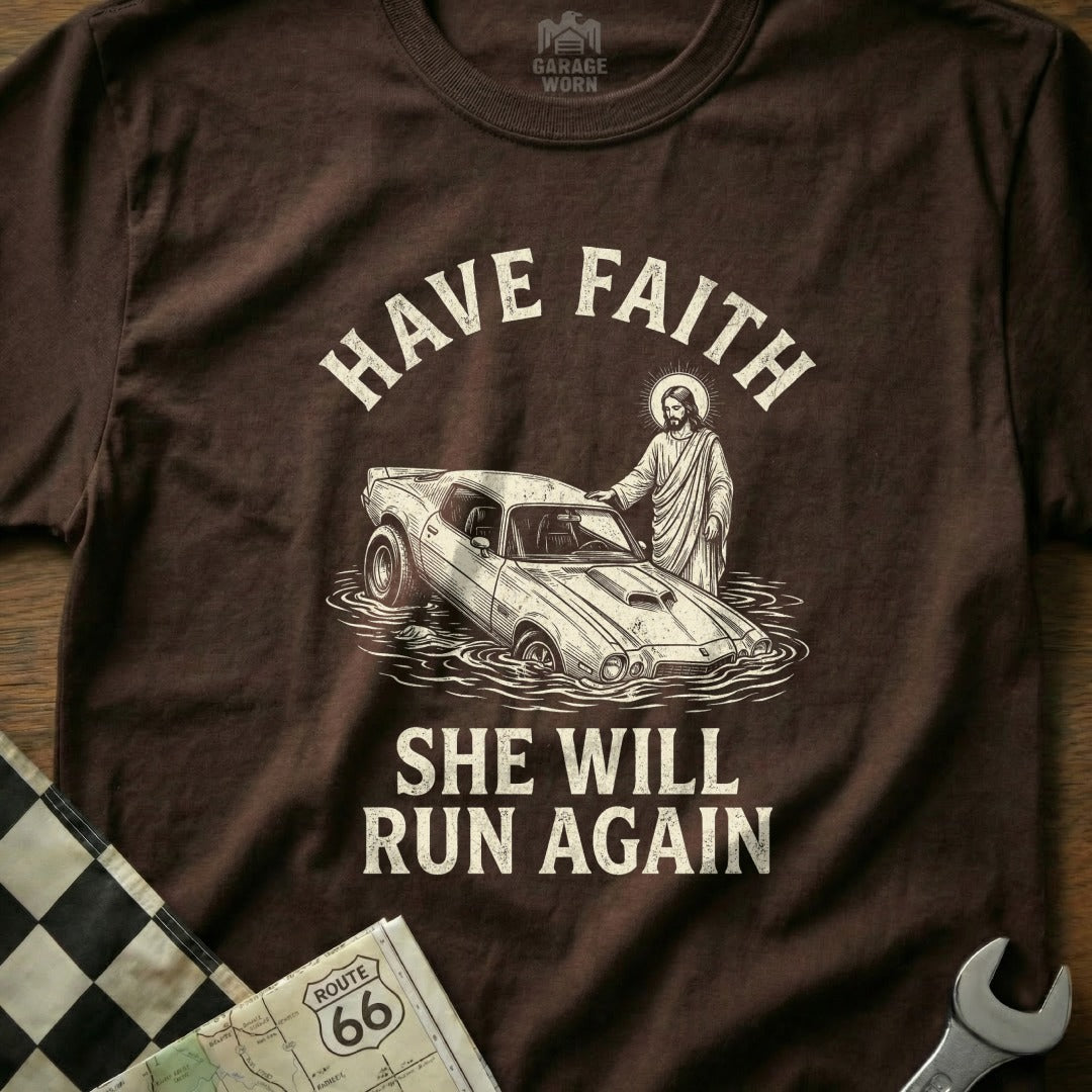 Brown t-shirt with "HAVE FAITH SHE WILL RUN AGAIN" and Jesus helping a submerged car.