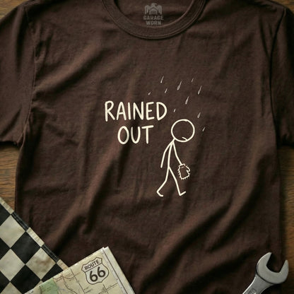 Brown t-shirt with stick figure under rain and text "RAINED OUT".