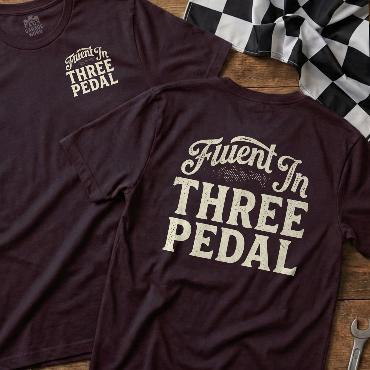 Maroon t-shirt with "Fluent In Three Pedal" text on back and front.