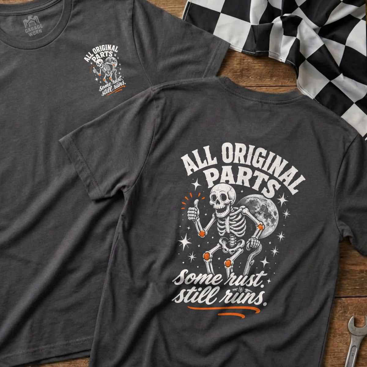 Dark grey t-shirt with skeleton graphic and "All Original Parts. Some rust. still runs." text.