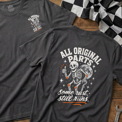 Dark grey t-shirt with skeleton graphic and "All Original Parts. Some rust. still runs." text.