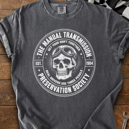 Manual Transmission Preservation Society graphic with skull wearing goggles on dark t-shirt.