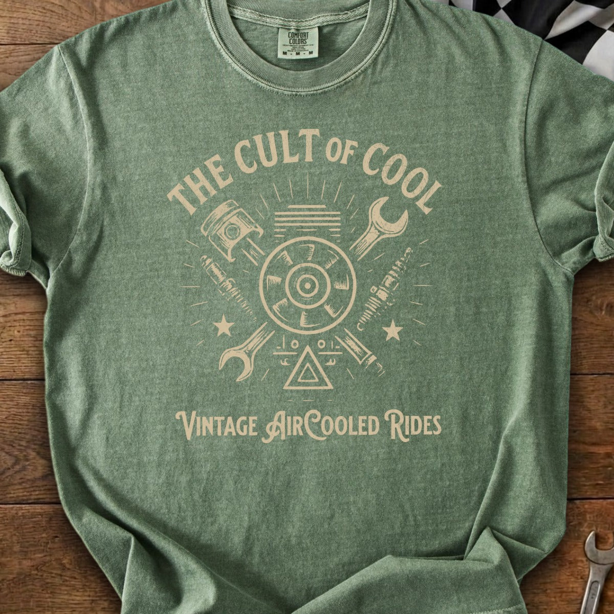 Green t-shirt with "The Cult of Cool Vintage Air-Cooled Rides" text and motorcycle parts graphic.