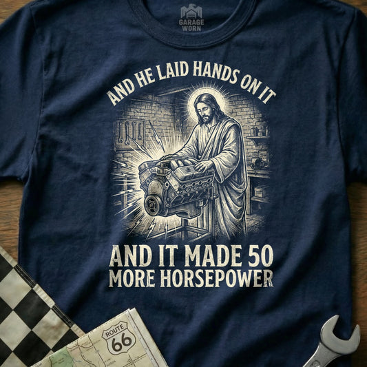 Jesus working on an engine with text: "And he laid hands on it and it made 50 more horsepower."