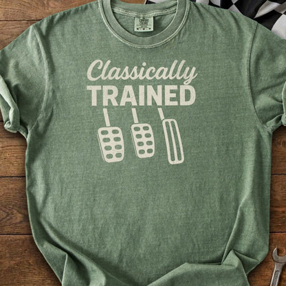 Green t-shirt with "Classically TRAINED" text and three manual transmission pedals.