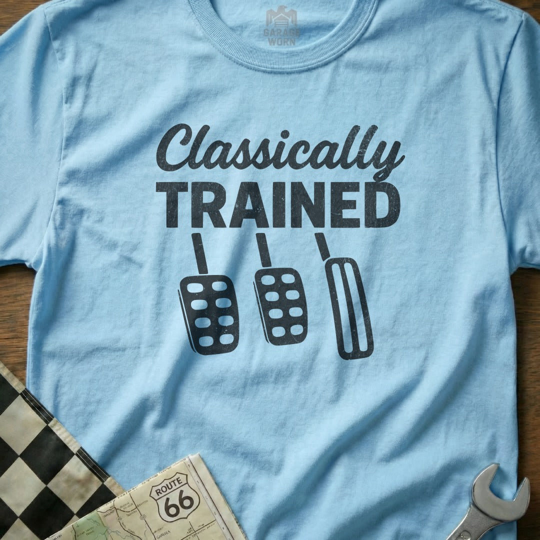 Light blue t-shirt with black text "Classically Trained" and three car pedals.